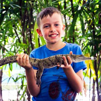 boy-holding-crocodile-wildlife-habitat-port-douglas